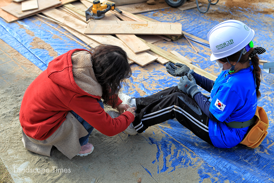 아잉뿌잉팀의 임요원(우측) 참가자의 신발끈을 묶어주고 있다   ⓒ지재호 기자